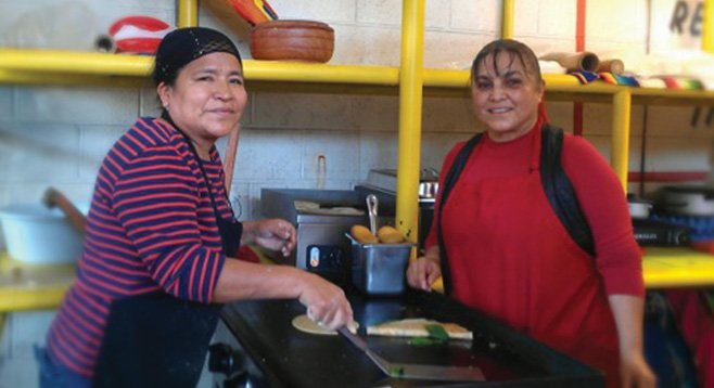 Saida Soto and Mercedes Roman would enjoy not having to haul, set up, and break down their café for every market day.