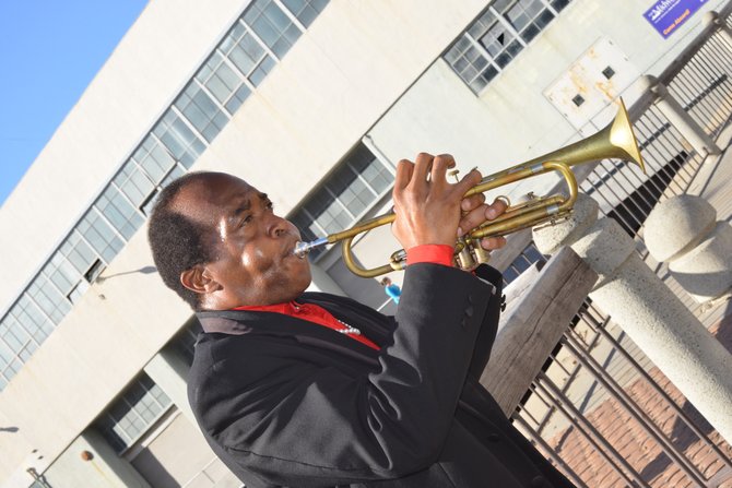 Daryl St. John performs a solo number on his trumpet next to the MIDWAY downtown San Diego. Photographed by Robert Chartier.