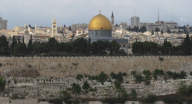 Jerusalem: walls of the Old City and the gold-capped Islamic Dome of the Rock.