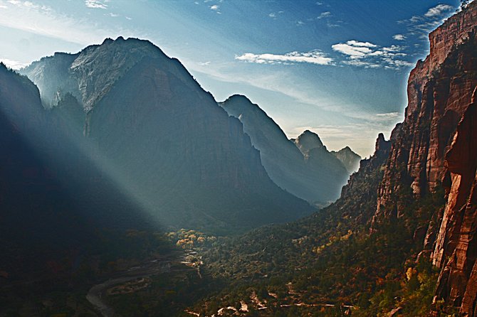 Sunlight filters through a mountain pass in Zion National Park.