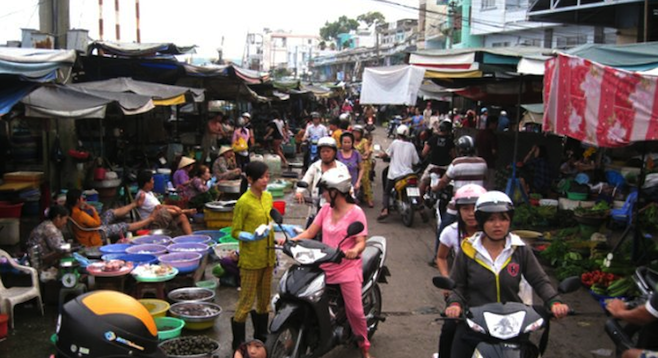 Navigating a crowded Saigon market on a motorbike: not for the faint of heart. 
