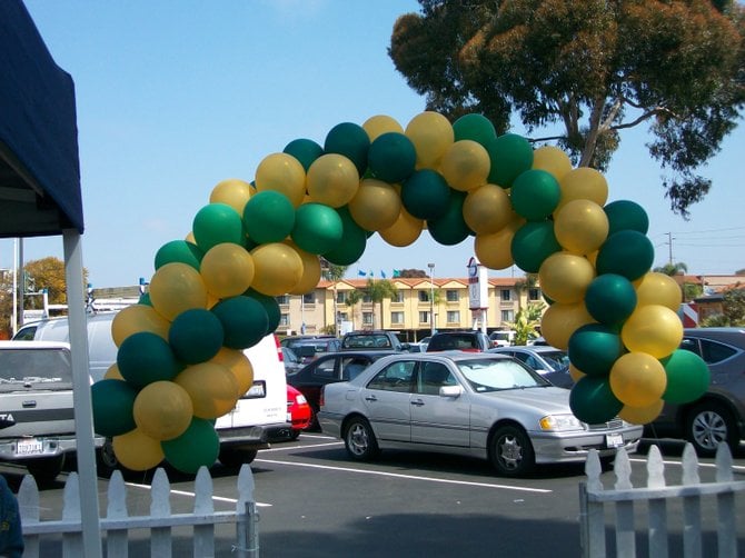 Colorful balloons decorate Grocery Outlet parking lot event in Pt. Loma.