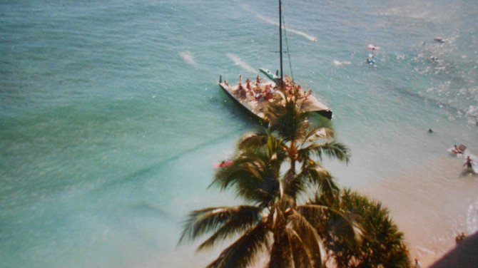 Watching a catamaran tour from my hotel balcony overlooking Oahu, Hawaii.