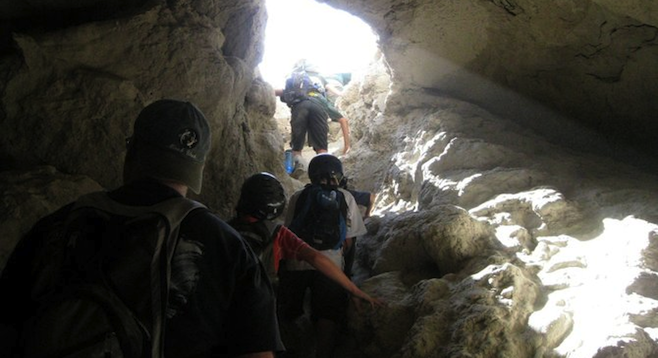 Climbing out of one of the many "mud caves" found in the Anza Borrego Desert. (Photo by Andrew Accardi)
