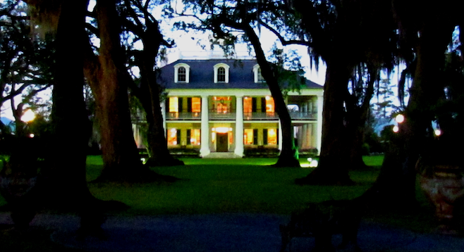 The grand Houmas House at dusk on the bayou. 
