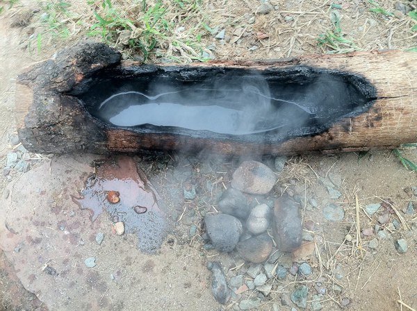 Clean water is critical to self reliance.  A container made from a log to hold the water and rock-boiling to make sure it is safe to drink.
