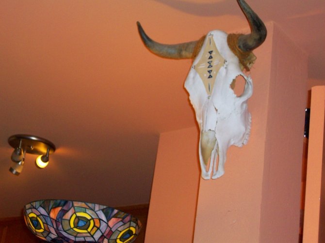 Cow skull found in Arizona desert mounted on wall of Green Tara Float Center in P.B.