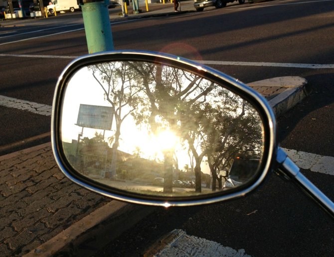 Here is a review mirror image of the sun through the trees just before the sun goes down for the evening..