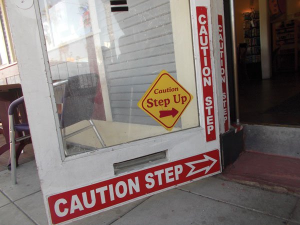 No less than four signs warn customers about 
the step up into the bar.
