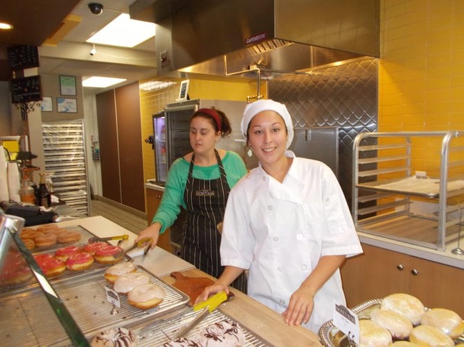 Server Emily and cook Sarai keep the donuts moving