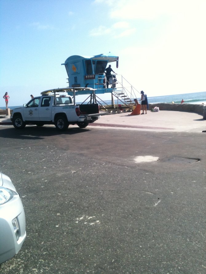 This armed lifeguard illegally parked in a red zone after threatening beachgoers with tickets for the same offense.