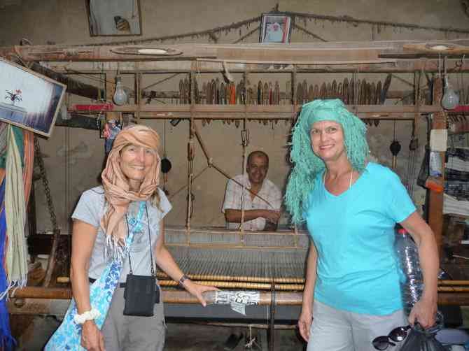 Trying on headwraps in the scarf-making shop. 