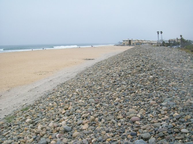 The cobblestone barrier between the beach and the Tijuana Estuary where a student paraglider was dragged to his death.