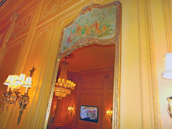 Eighteenth-century French tapestries and gilded-frame mirrors hang on the walls.