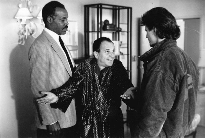 The Skin Diver Shock or the 'Wanna' check for foreskin, Mel?' cut: "L.A. police detectives Roger Murtaugh (DANNY GLOVER, left) and Martin Rigg's (MEL GIBSON, right) latest official duty is to provide protective custody to Leo Getz (JOE PESCI), an accountant who has laundered nearly half a billion dollars in narcotics money, in Warner Bros.' new action-thriller 'Lethal Weapon 2.'"