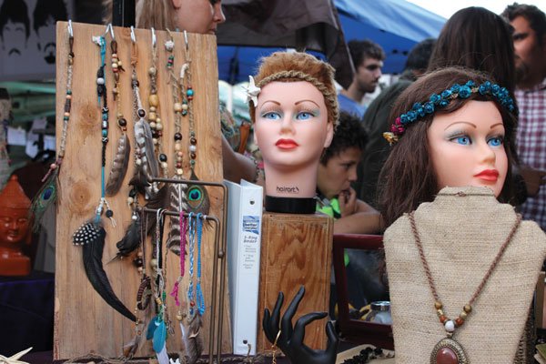 Hemp, feathers, and beads on disembodied mannequin heads