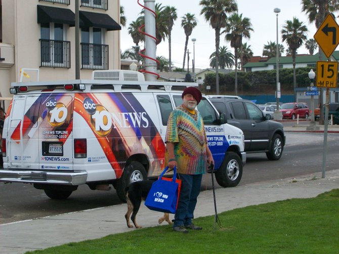 Volunteer with dog at Marshmallow clean-up in Ocean Beach.