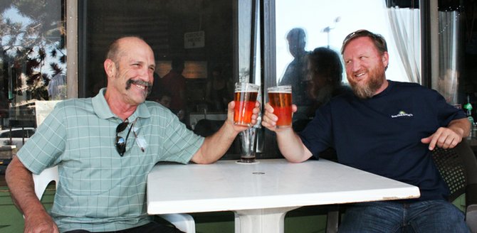 Alpine Beer Co.'s owner Pat McIlhenney (left) toasts new brewing arrangement with Green Flash brewmaster Chuck Silva