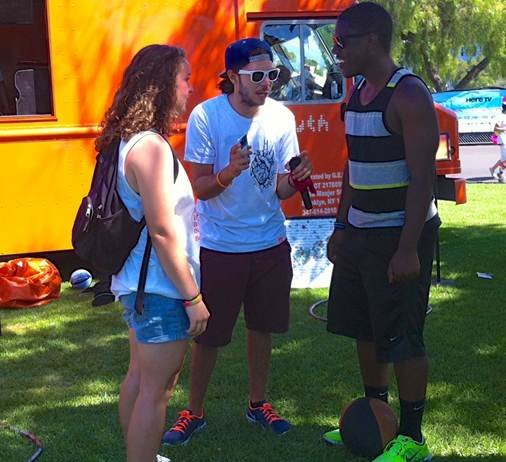 truth®  tour rider Paul (center) prepares Kelly Roddy, 20 (left), of Poway, CA and Roderick Knighten, 21 (right), of San Diego, CA, for a game inside the truth®  zone at San Diego Pride. truth® stopped at San Diego Pride as a part of the truth® national tour, aimed at educating teens and young people about tobacco use. truth® is the nation’s largest youth smoking prevention campaign.