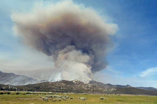 Smoke and flames rise from what is being called the Mountain fire, in the San Jacinto Mountains near the town of Hemet. The fire is currently threatening the town of Idyllwild,.