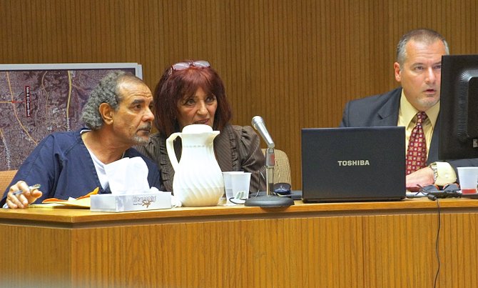 Alhimidi and interpreter and def attorney watch video surveillance on monitor, in court. Photo Weatherston.