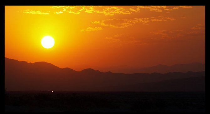 Sunrise in the Mojave Desert - there is also a train (you can see its light in the bottom left hand corner, where the mountains start).