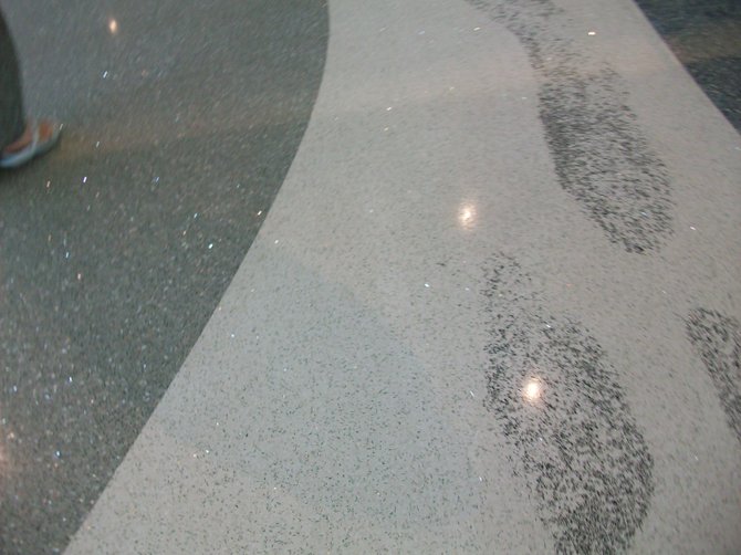 Footprints in the sand design on floor of Terminal 2 expansion at downtown's San Diego airport.