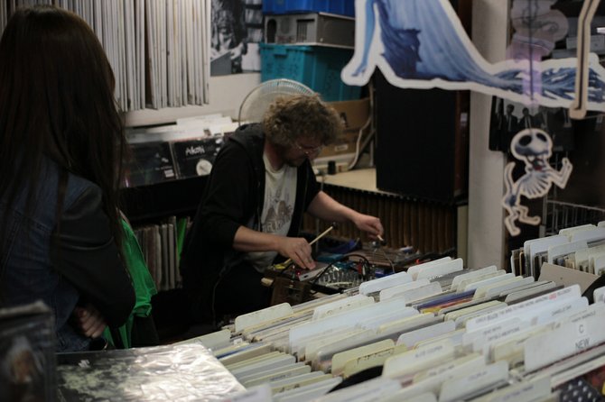 A noise musician performs in a record shop as part of the Village Walk.