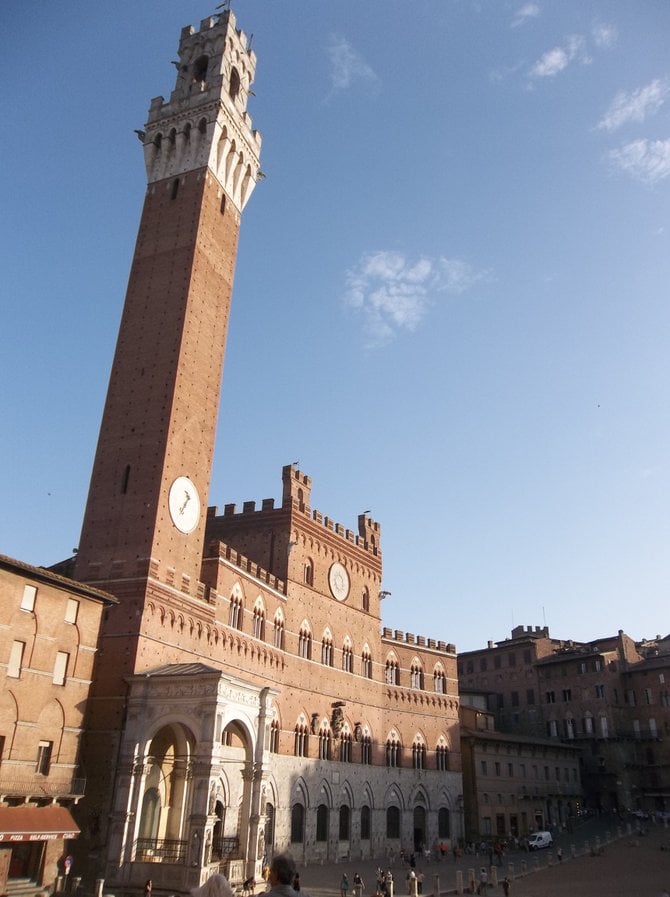 The Torre del Mangia towers over the Piazza del Campo in Siena, Italy