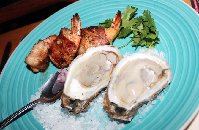 Bahia Falsa oysters served on the half-shell with three bacon-wrapped shrimp.