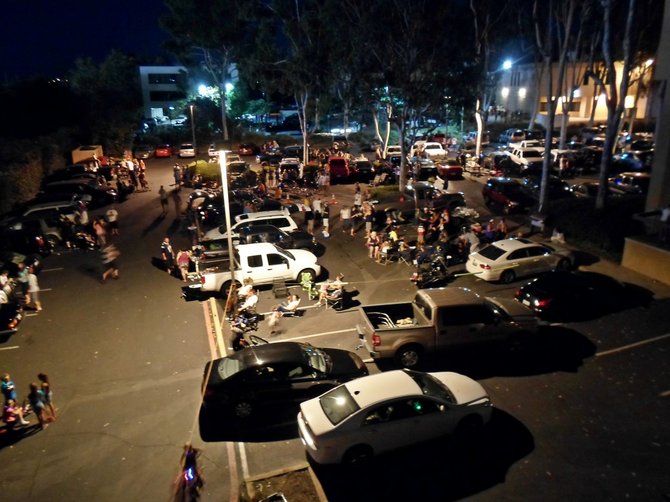Waiting for the show to begin — the crowded parking lot as seen from the roof.