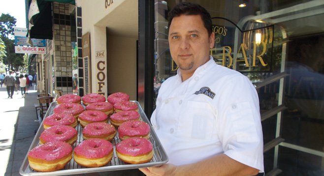 Santiago Campa outside the shop with a tray of raspberry-pistachio donuts