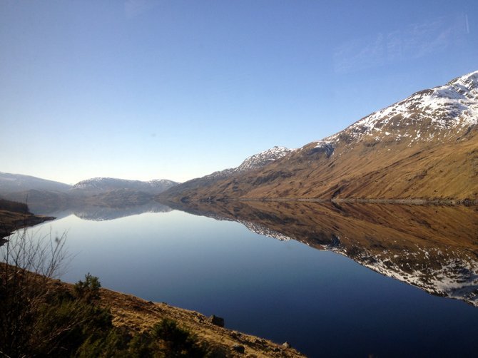 One of the many eerily still lochs of the West Highlands. Glasgow to Mallaig, one of the most beautiful train rides in the world.

