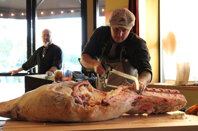 Heart & Trotter butcher James Holtslag breaks down some beef at an Alchemy demo. Photo: Chad Deal