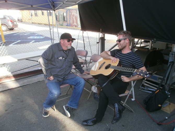Michael Halloran of 91X holding court backstage at the Ohio St. block party. Photo by Bart Mendoza.