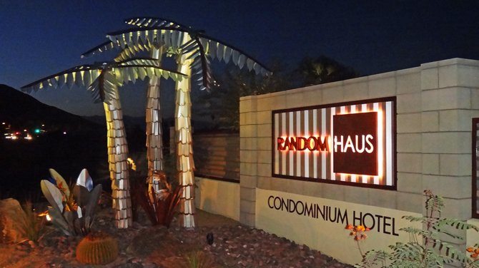 Random Haus Condominium Hotel sign at night