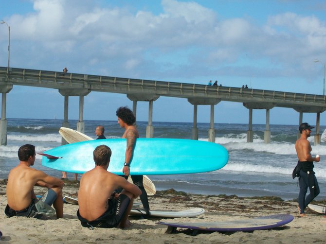 Surfers get ready to Paddle Around the Ocean Beach Pier for Clean Water.