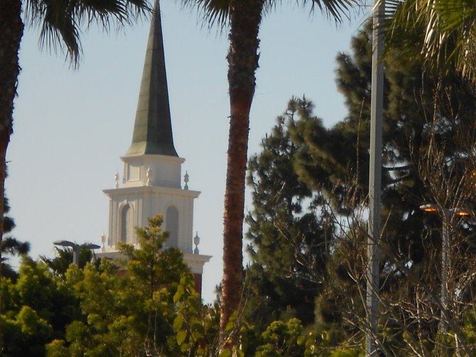 Red Brick Church bell tower in Point Loma through the trees.