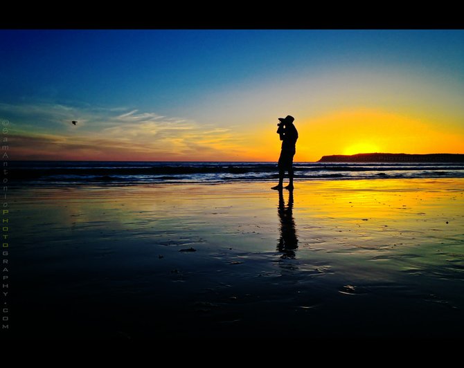 Silhouette of a photographer at sunset in Coronado Beach.