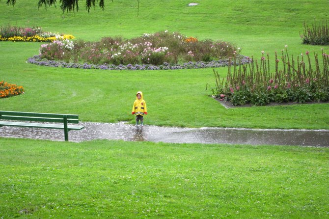 A little boy stands in a puddle during the rain at San Francisco's Golden Gate Park.