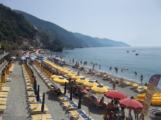 View from the beach at Monterosso al Mare, Italy looking south. Other Cinque Terre towns, including Vernazza, are slightly visible at the base of the hills.