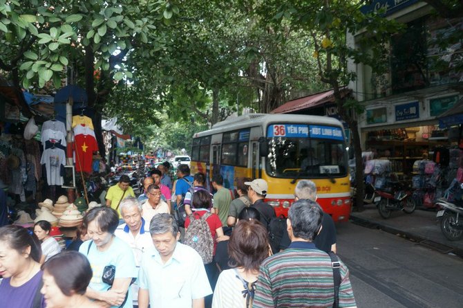 Everyone struggles for their space on the street, whether it's a bus, motor bike or pedestrians.