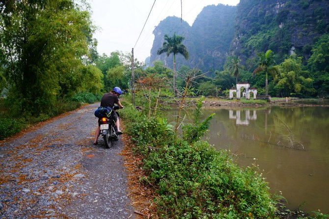 A small road in between majestic mountains on the way to Cuc Phuong National Park.