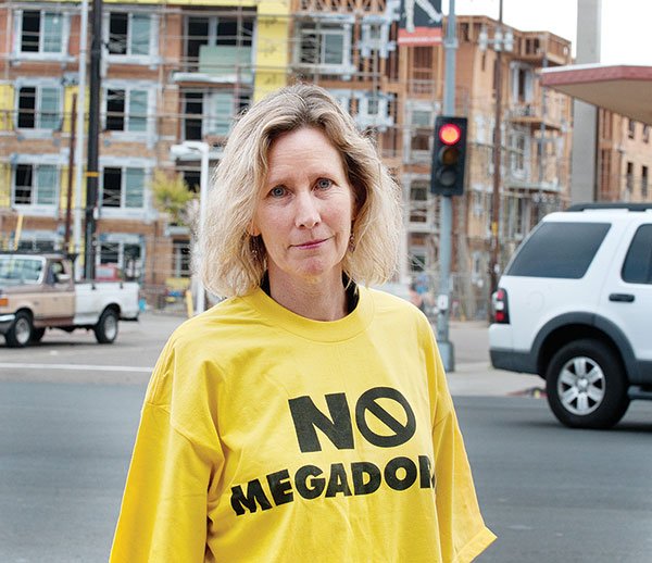 “No Megadorms,” reads the T-shirt on Rolando resident Karen Collins, who warns, “This single development will add 50 percent to Rolando’s population.”
