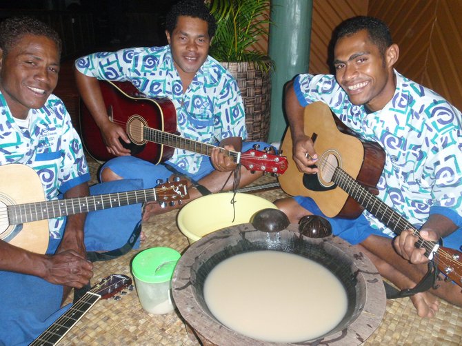 Fijians playing guitar at the kava ceremony. 