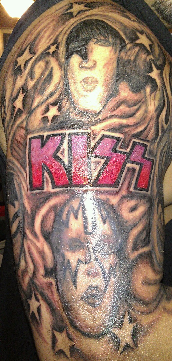 I've been a huge KISS fan since I was a young lad.....I've had the logo since college and within the last couple of years added the faces around the logo....and about a month ago I showed Paul & Gene my arm and they both loved this original piece!
Got it done at Revelations Tattoo Shop in El Cajon....I'm 42 and will still get more tats....619-818-3353
