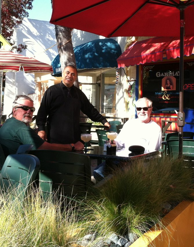 Waiter José Payo serves Dan and Ron from Las Vegas