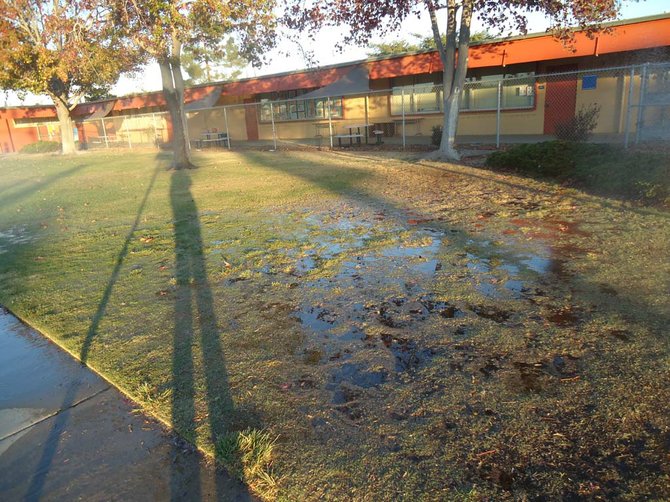 A huge puddle makes itself known at Holmes Elementary School.