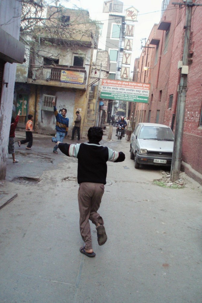 Boys playing cricket in Delhi, India