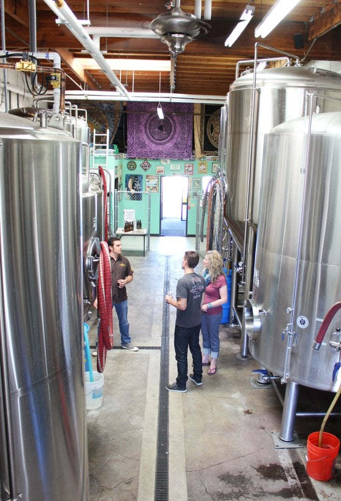 Mother Earth Brew Co.'s Kamron Khannakhjavani shows fans around the brewery during his company's open house event.